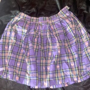 This skirt is a small and goes a little above mid thigh.